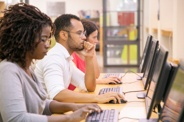 Customer Care team creating a survey on a computer for customer feedback