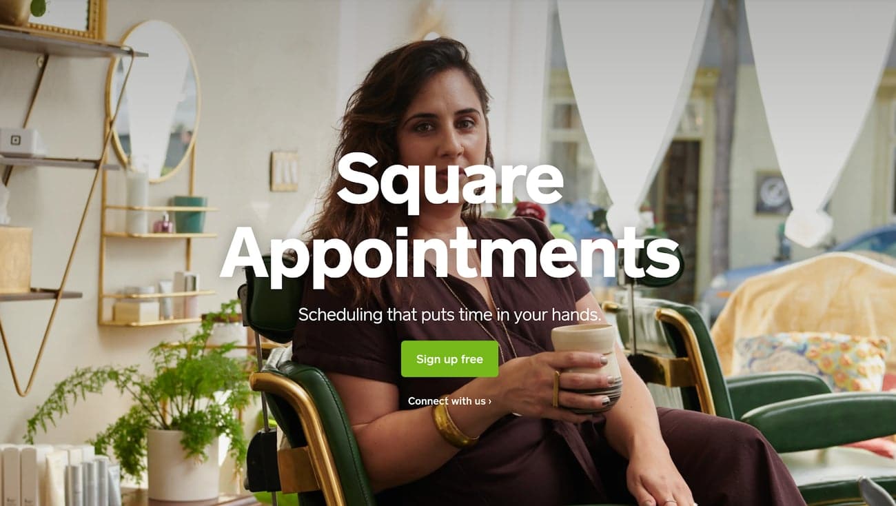 Square appointment scheduling app with an image of a woman sitting in a chair drinking a cup of coffee